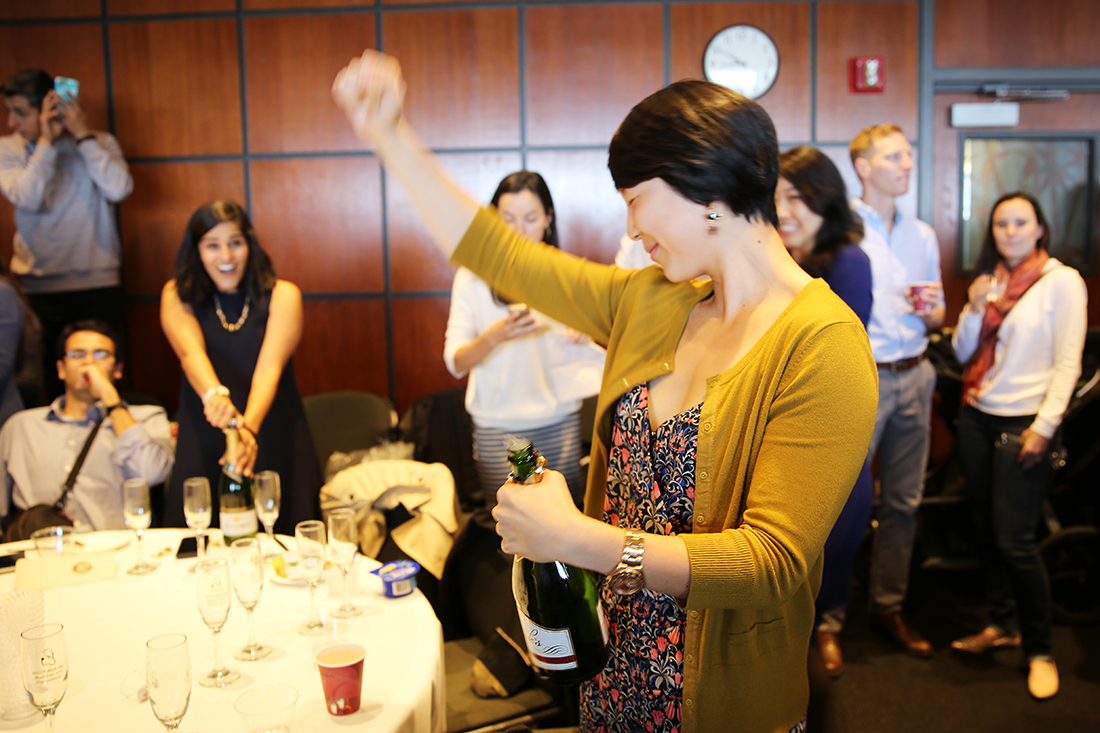 Jeyling Chou pops open a champagne bottle to celebrate her "match" with a program in Santa Clara.