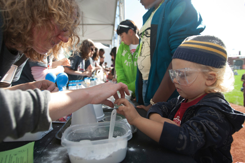 Biochemist Margaret Elvekrag helps Hudson O'Neal, 5, in a carbon dioxide demonstration.