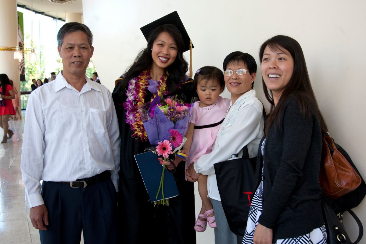 UCSF dental school graduate Cai Zhang takes a family photo after the commencement ceremony.