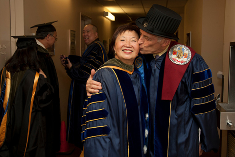 UCSF School of Pharmacy Dean Mary Anne Koda-Kimble, left, gets a kiss from professor Leslie Benet before the commencement ceremony.