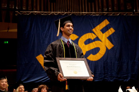 UCSF School of Pharmacy student Akash Dandappanavar receives a certificate of nomination for the Bowl of Hygeia award at commencement.