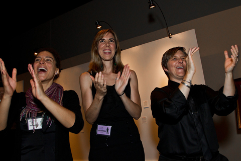 Art For AIDS volunteers applaud the highest bidder of a sale during the live auction.