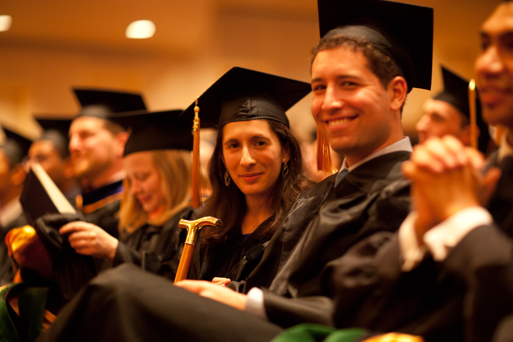Rachel Stern, center, holds the Gold-Headed Cane, which symbolizes the ideals of the true physician, after her classmates selected her the award.