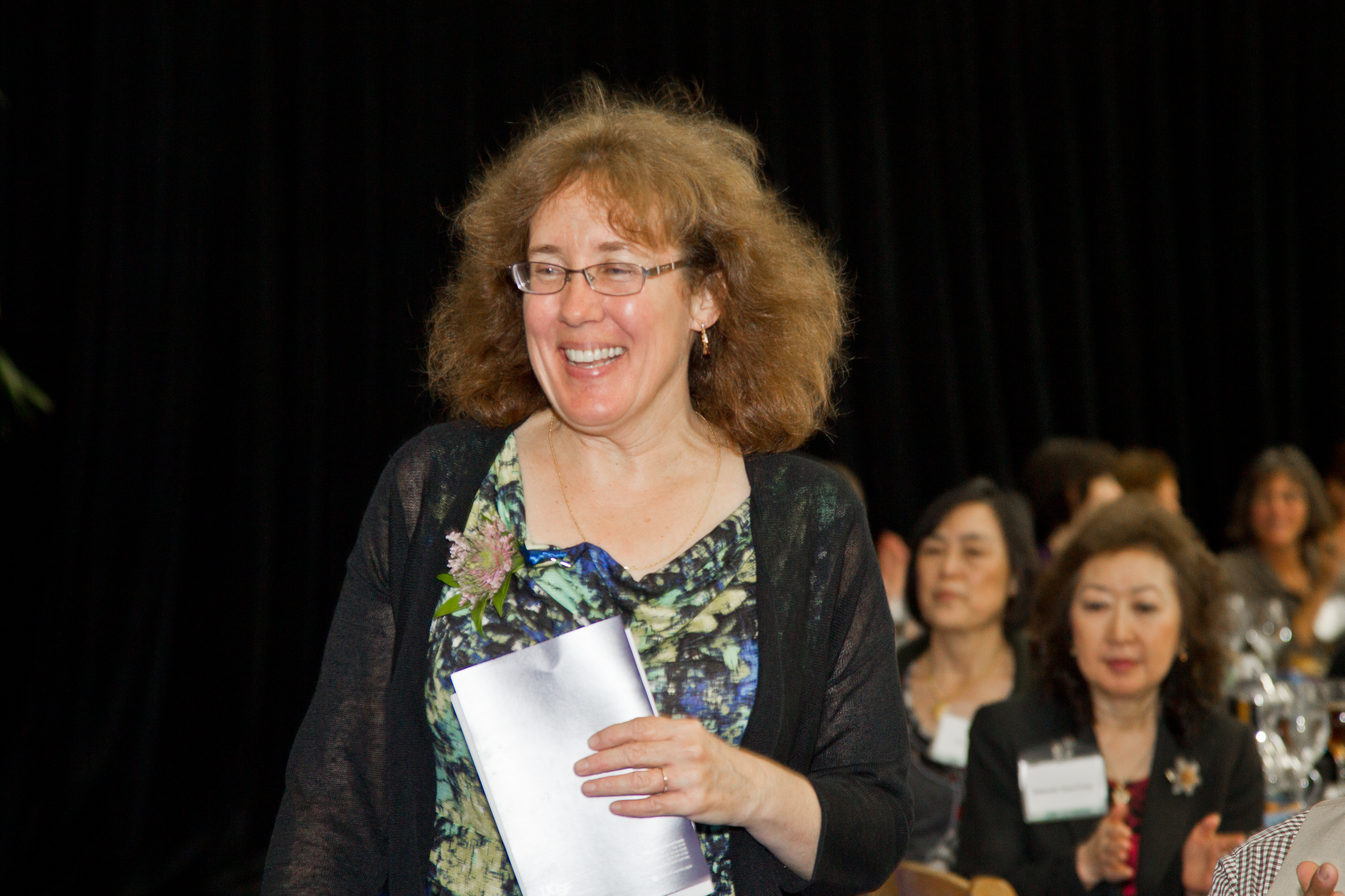 Katherine Murphy, who also won an exceptional univeristy service, stands to accept her award.