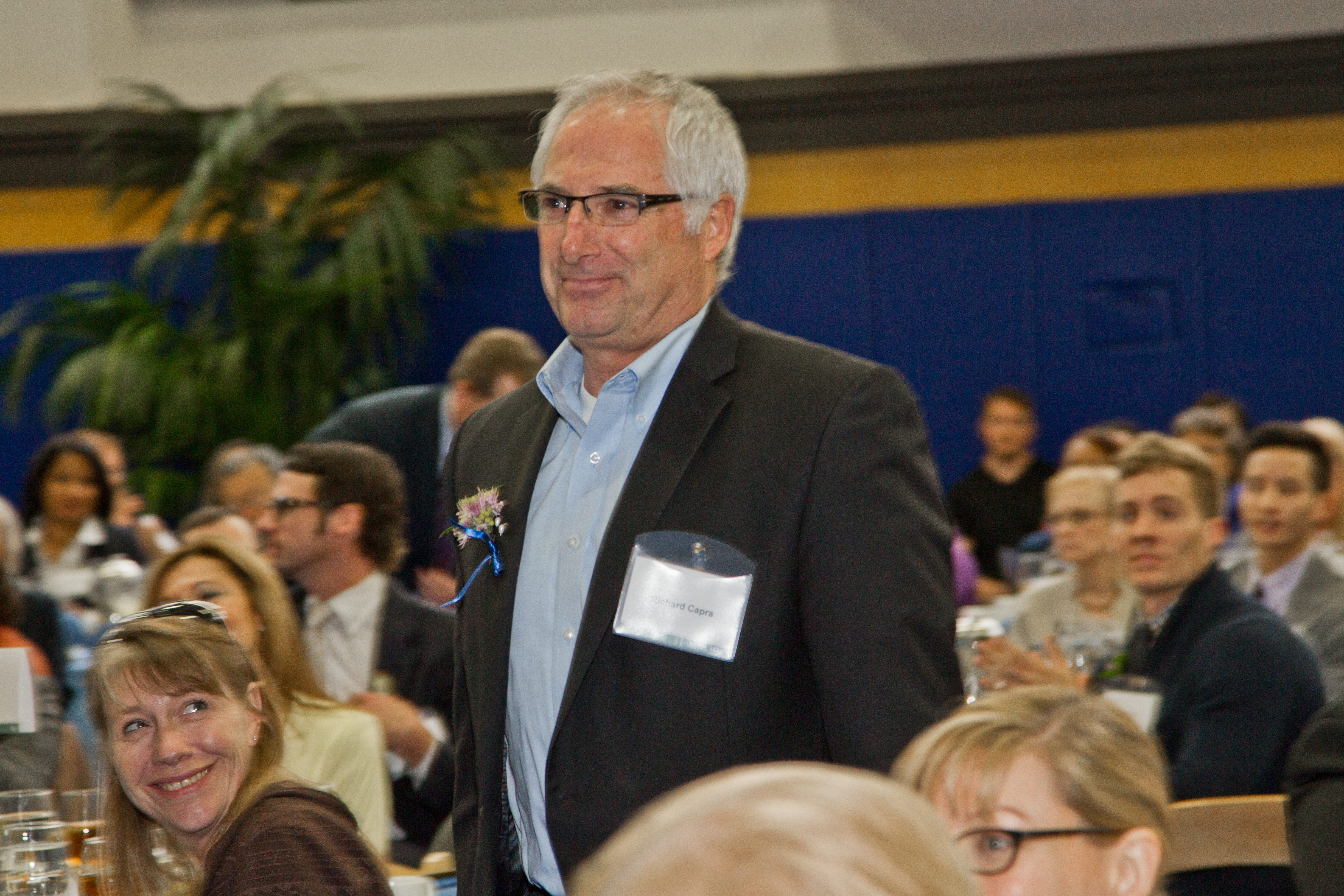 Richard Capra, who won the Chancellor's Award for Exceptional University Management, walks to the podium to receive his award from the chancellor.