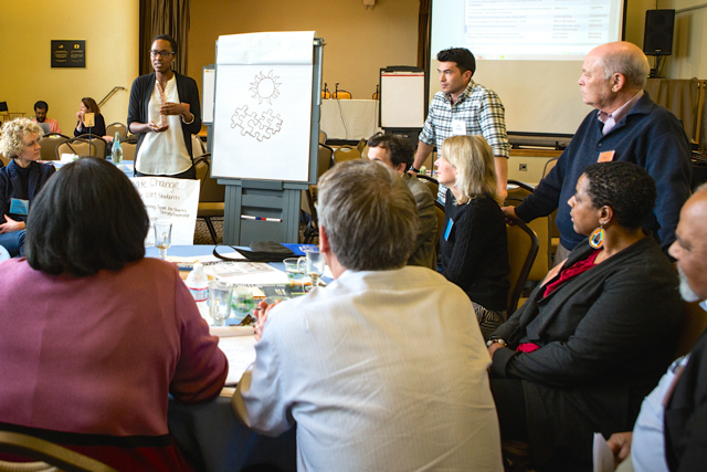 Medical student Sidra Bonner leads a discussion on race at the Jan. 9 retreat, as School of Medicine Dean Bruce Wintroub (far right, standing) and others listen.