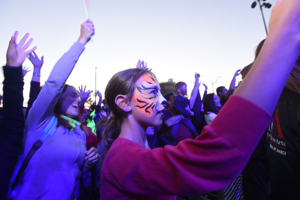 Marissa Holmes, 10, whose sister was a cancer patient at UCSF Benioff Children’s Hospital San Francisco, asked to be turned into a tiger at the face-painting booth, then enjoyed the performances at the Lights On Festival.