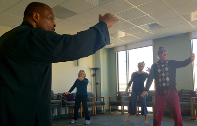 Joseph Acquah, OMD, teaches qigong to a group of patients 