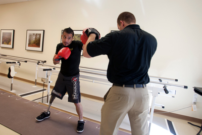 Coach Tim Baldwin works on boxing techniques with Carlos Gonzalez.