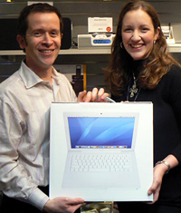 Garrett Schwartz, awards a MacBook to Catharine Freyer