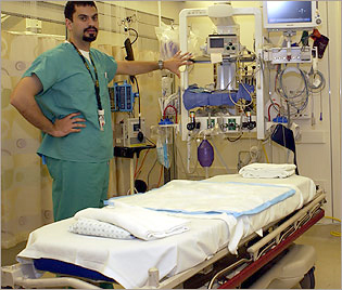 Brian Vansacker, an emergency room technician, shows off one of the newly remodeled rooms in the emergency department