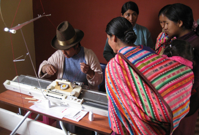 Women in Chitipampa, Peru, examine new sewing equipment at a textile factory