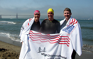From left, Aimee Sznewajs, Janel Jorgenson and Robert Goldsby emerge from San Francisco Bay at the conclusion of the Swim Across America relay swim on Saturday.