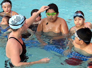 Children learn tips on swimming during a clinic with Olympians at Bakar Fitness Center at UCSF Mission Bay.