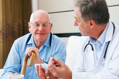 stock image of doctor discussing medication with elderly male patient