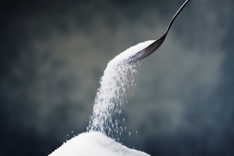 stock image of a sugar pouring out of a spoon
