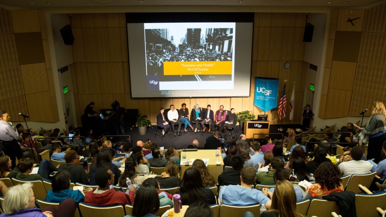wide view of a packed Cole Hall auditorium during the teach-in