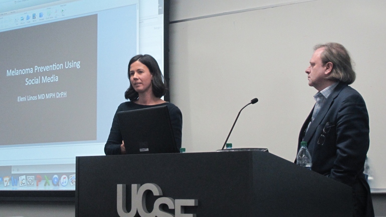 Eleni Linos presents during the UCSF Cancer Center Impact Grant live event as Alan Ashworth looks on.