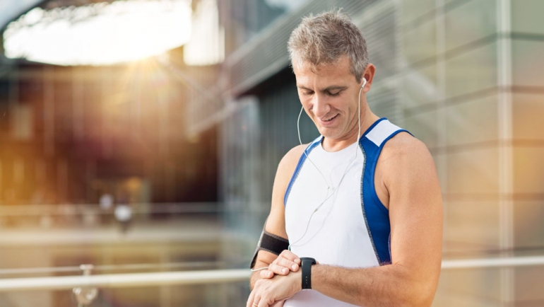 stock image of mature man taking a break from jogging