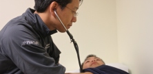 Medical physician checks heart rate of athlete