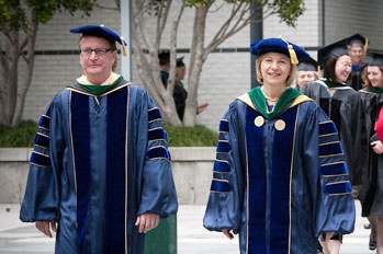 Sam Hawgood and Susan Desmond-Hellmann walk to the 2012 School of Medicine commencement ceremony.