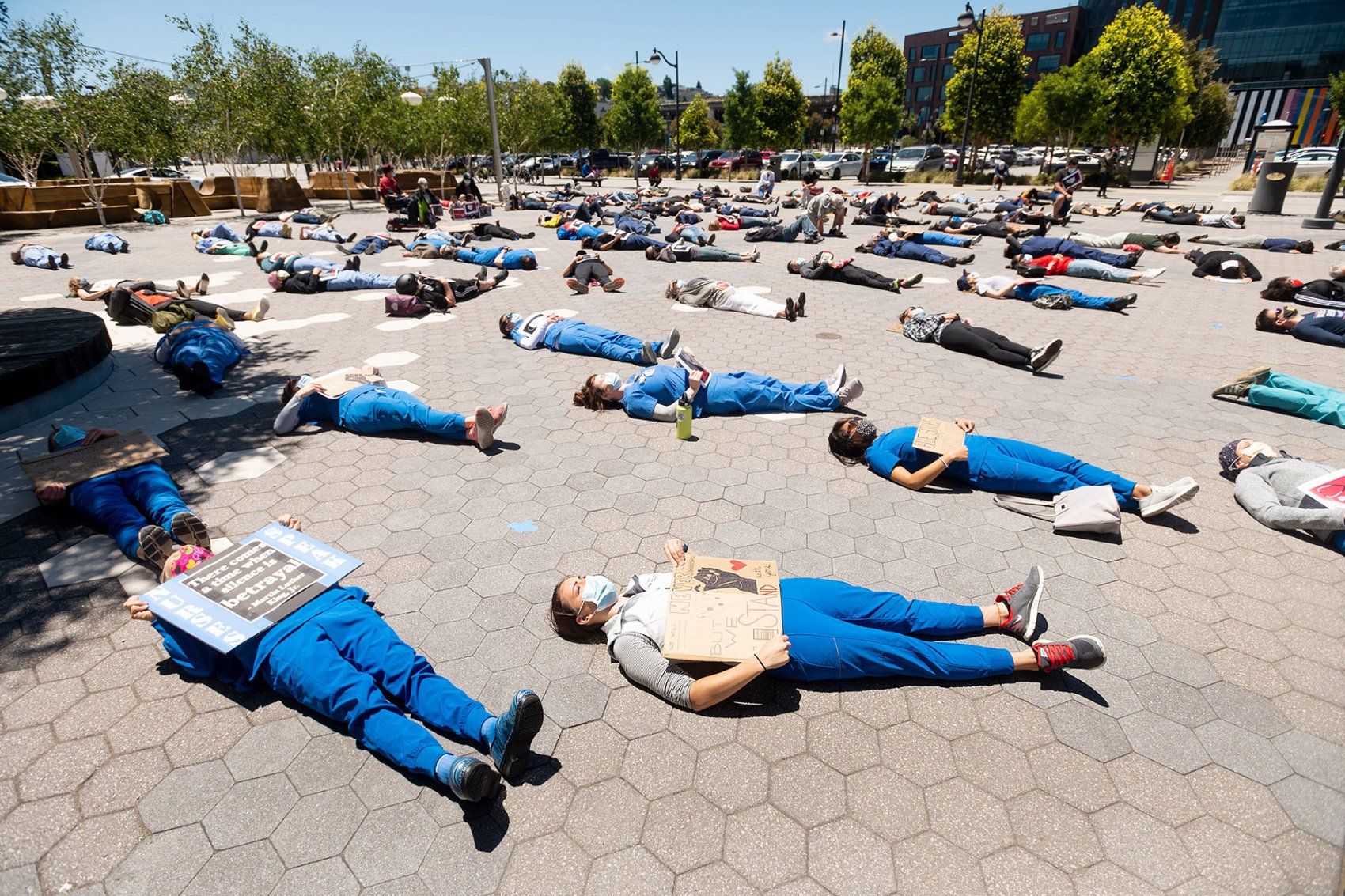 people lie down for a "die-in" during a rally
