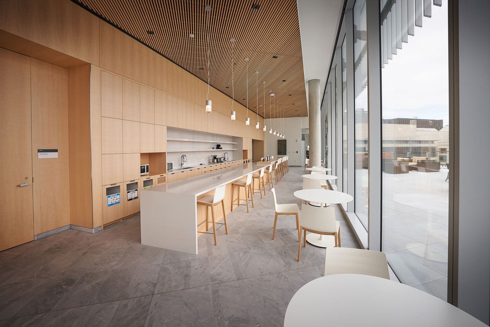 White tables and chairs in an eating area inside the Weill Neurosciences Building