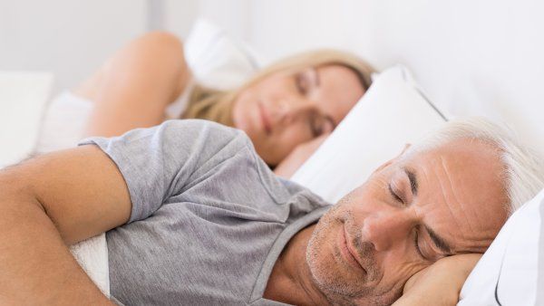 a photo of an older man and woman sleeping