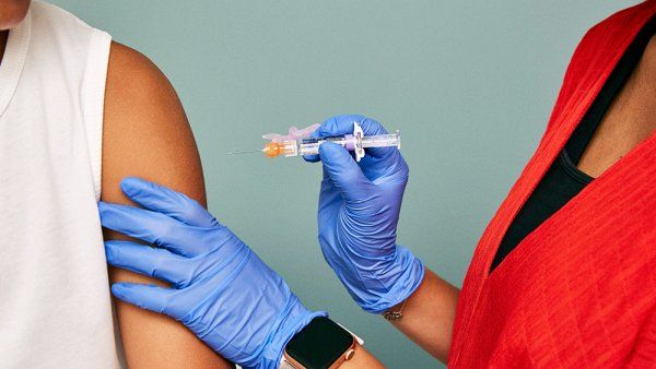 Doctor preparing to administer vaccine shot. 