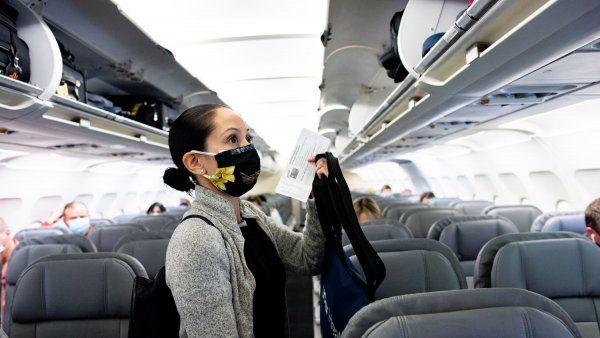 Nurse wearing face mask boarding plane