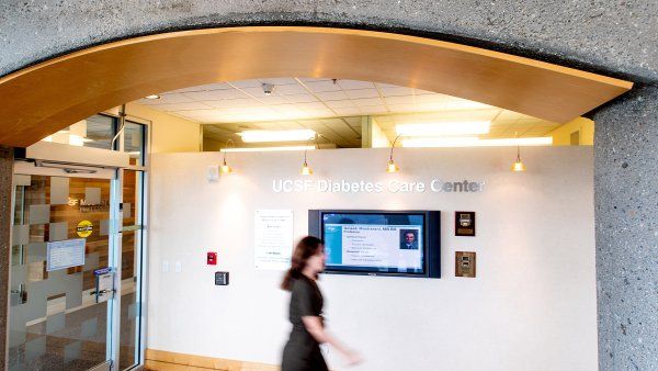 person walks by the sign of the UCSF Diabetets Care Center