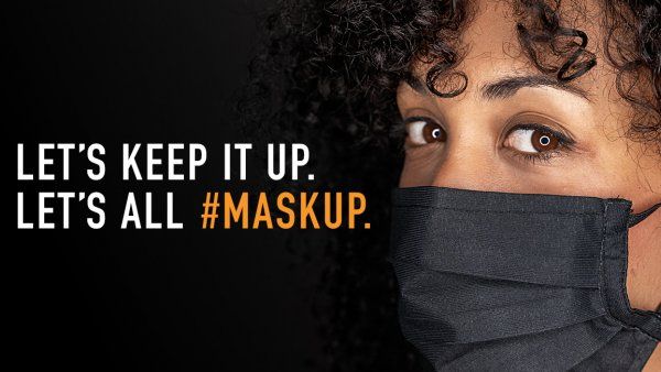 Woman wearing a face mask with text: Let's keep it up. Let's all #MaskUp