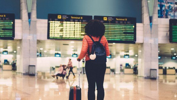 woman standing in an airport terminal