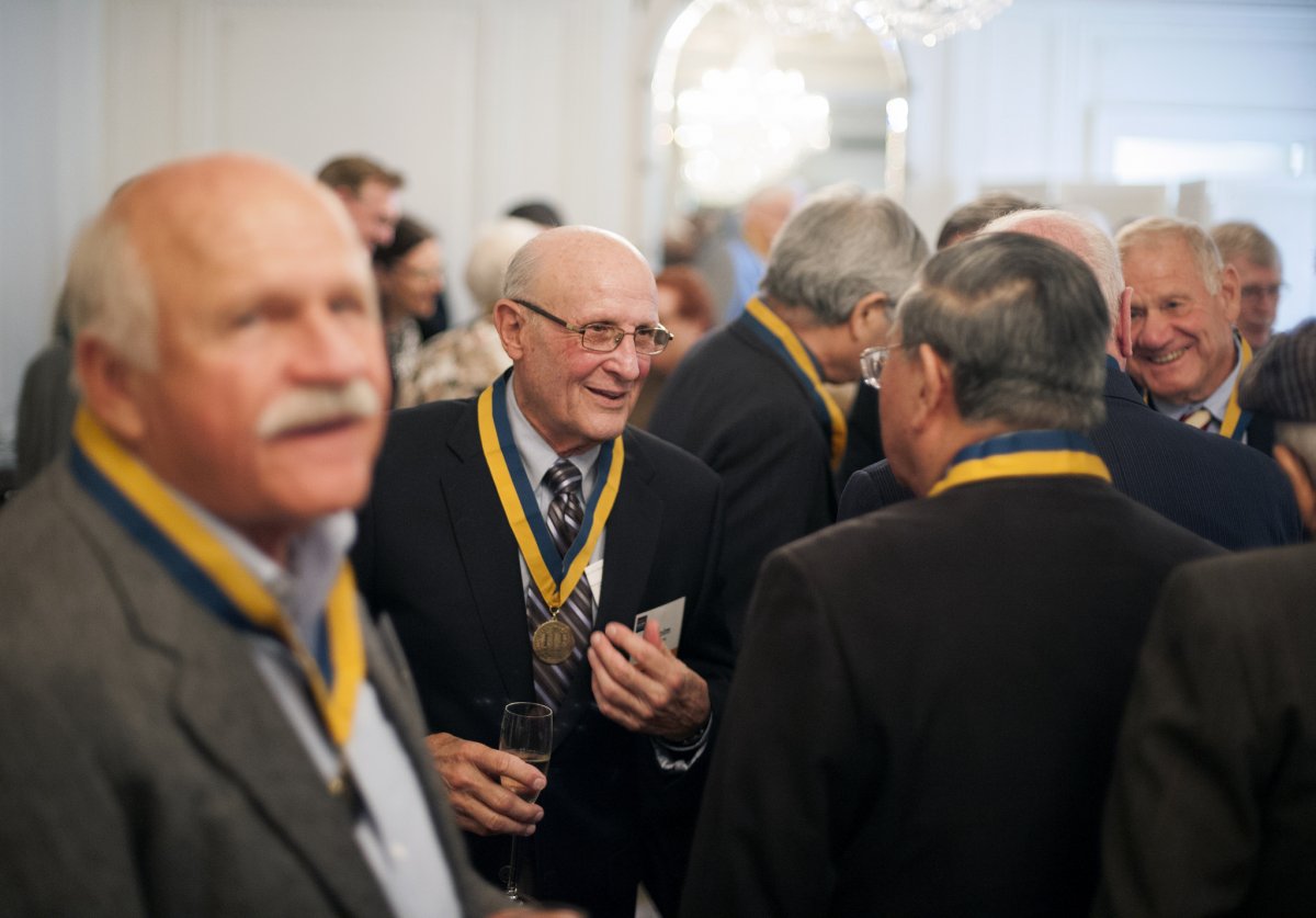 Robert Bechard, MD (Medicine '64), left, Malcolm Margolin, MD (Medicine '64), and Collin Quock, MD (Medicine '64), congratulate each other at the School of Medicine's 50 Year Medallion Ceremony.