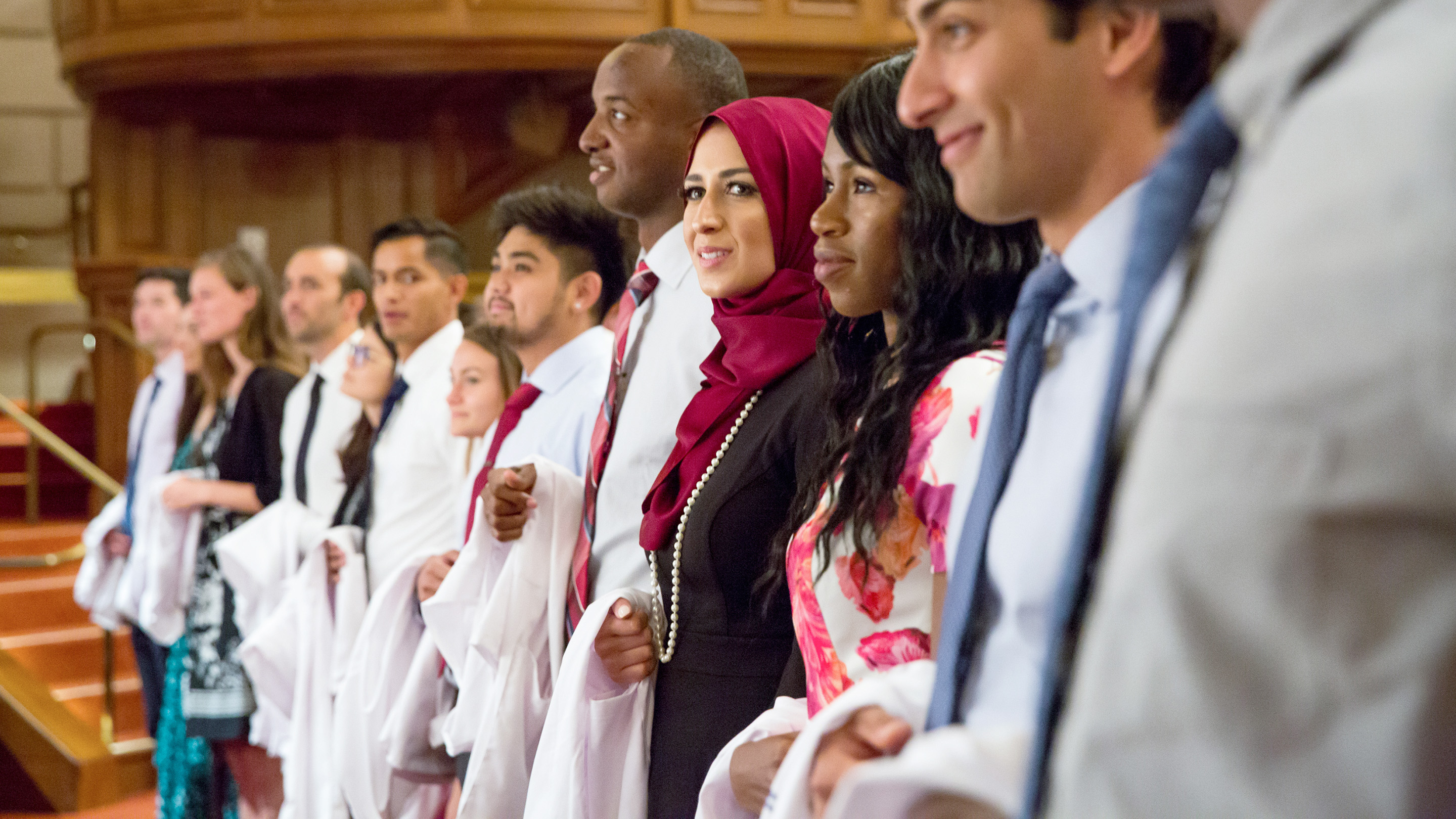 students stand together during white coat ceremony