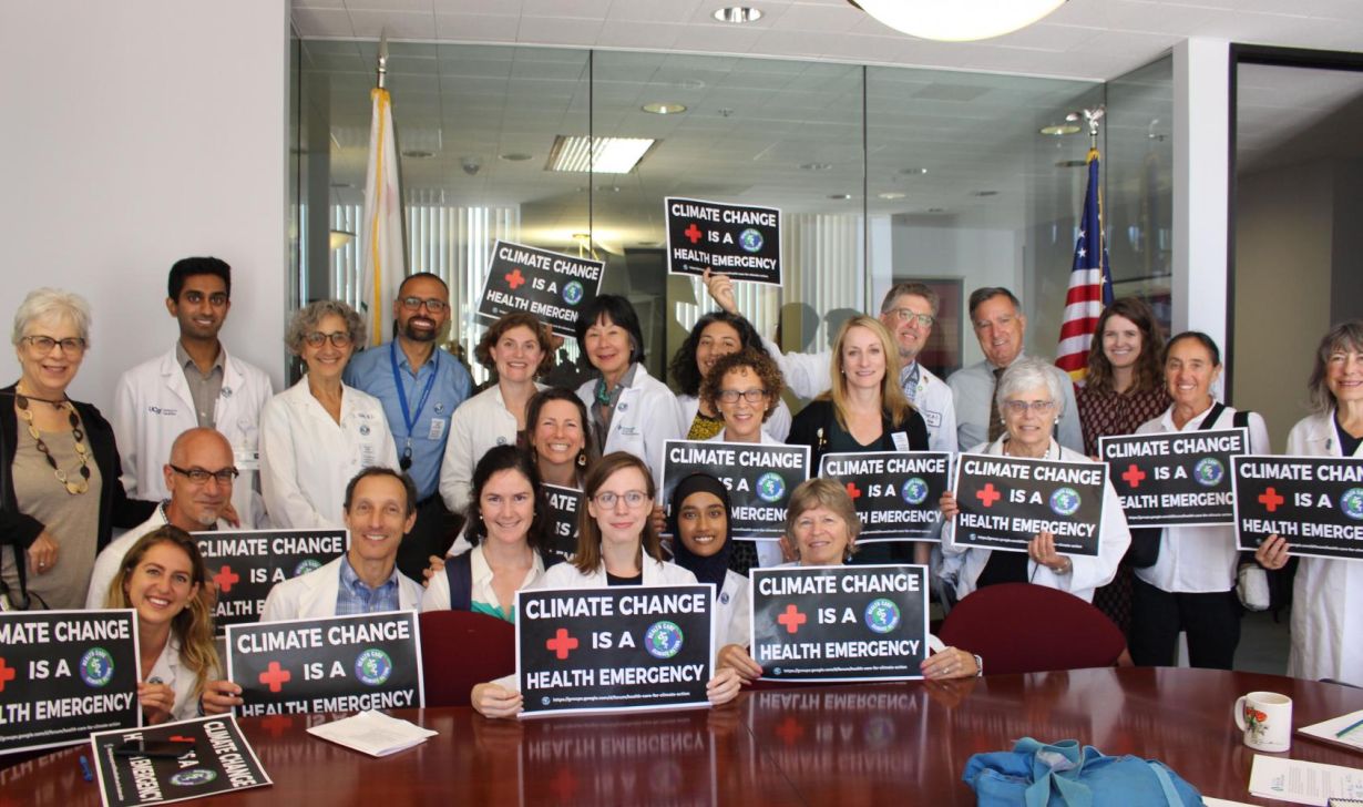 UCSF Students and Faculty at Senator Dianne Feinstein's office holding signs that read "Climate Change is a Health Emergency"