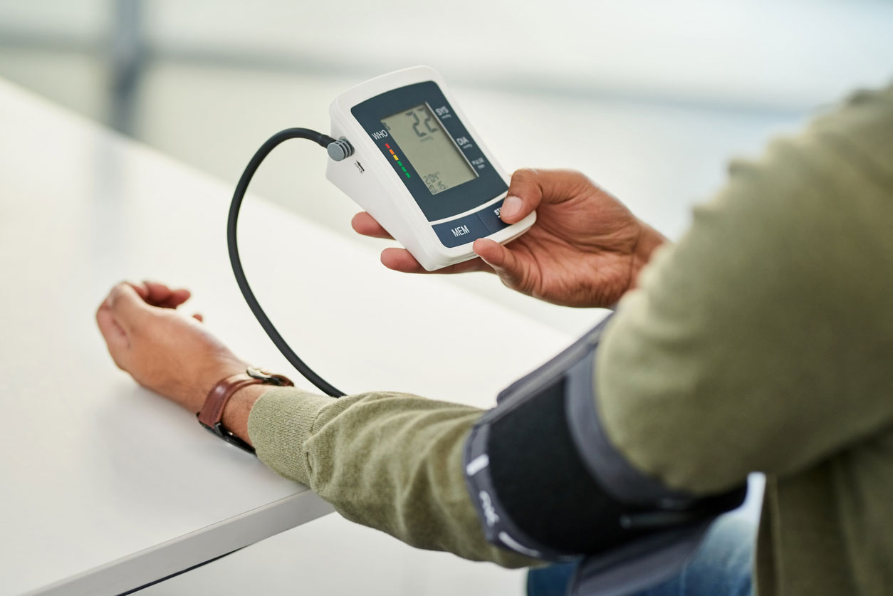 A man checking his blood pressure with a home blood pressure test