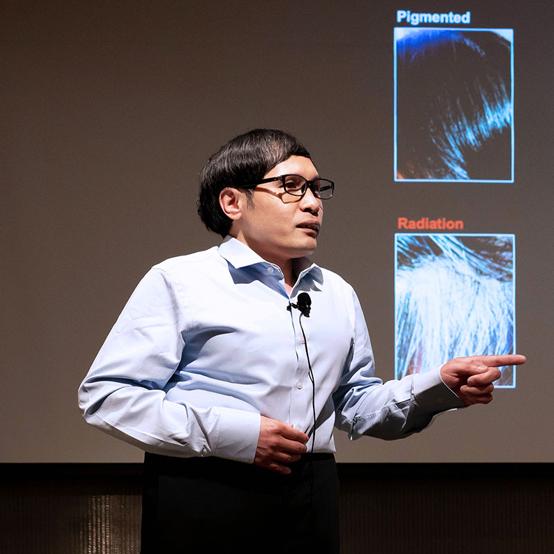 Postdoctoral student Jianlong Li presents research onstage