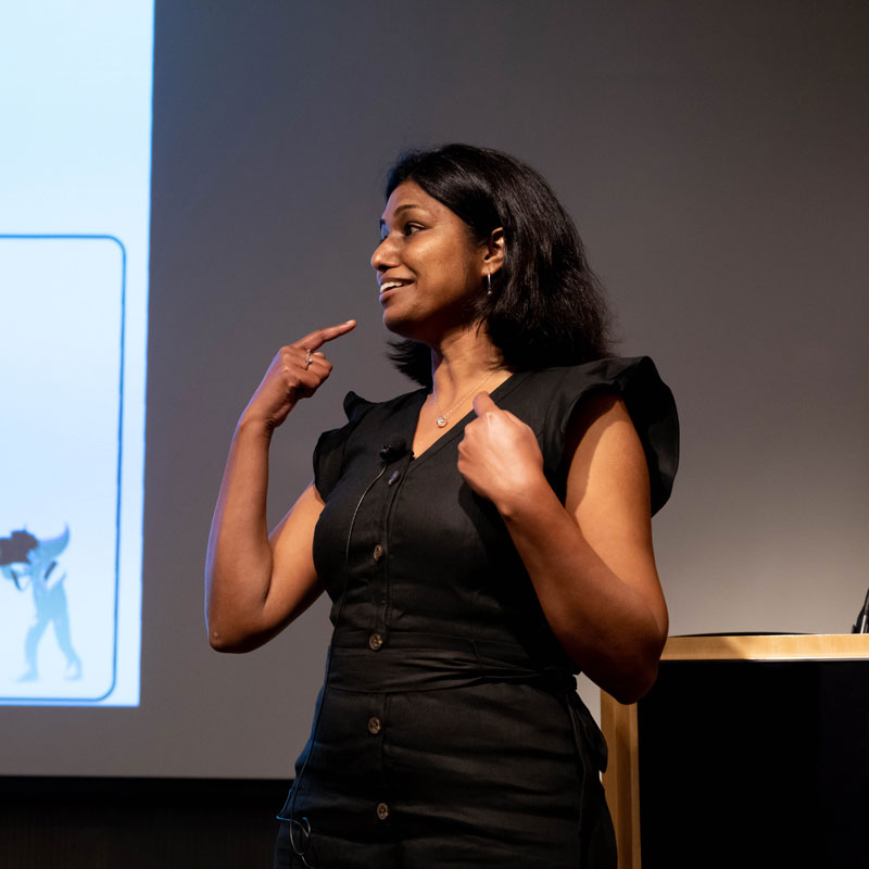 Postdoctoral student Sangeetha Kandoi presents her research onstage