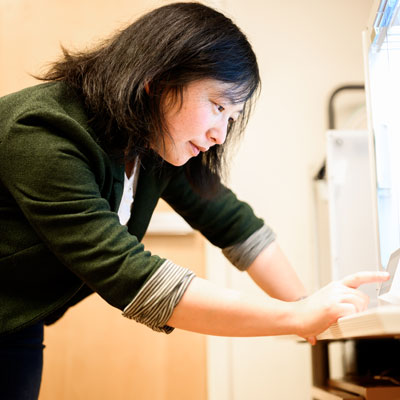 Qili Liu touches a screen in her lab