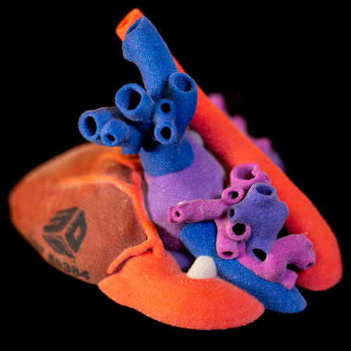 A 3D-printed heart made of red, blue, and purple 3D printing material.