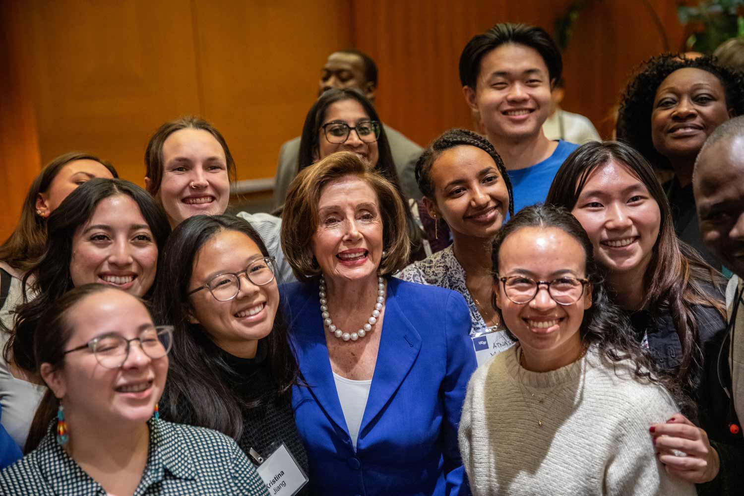 Nancy Pelosi stands for a photo with students from the Global Health Sciences departement at UCSF.