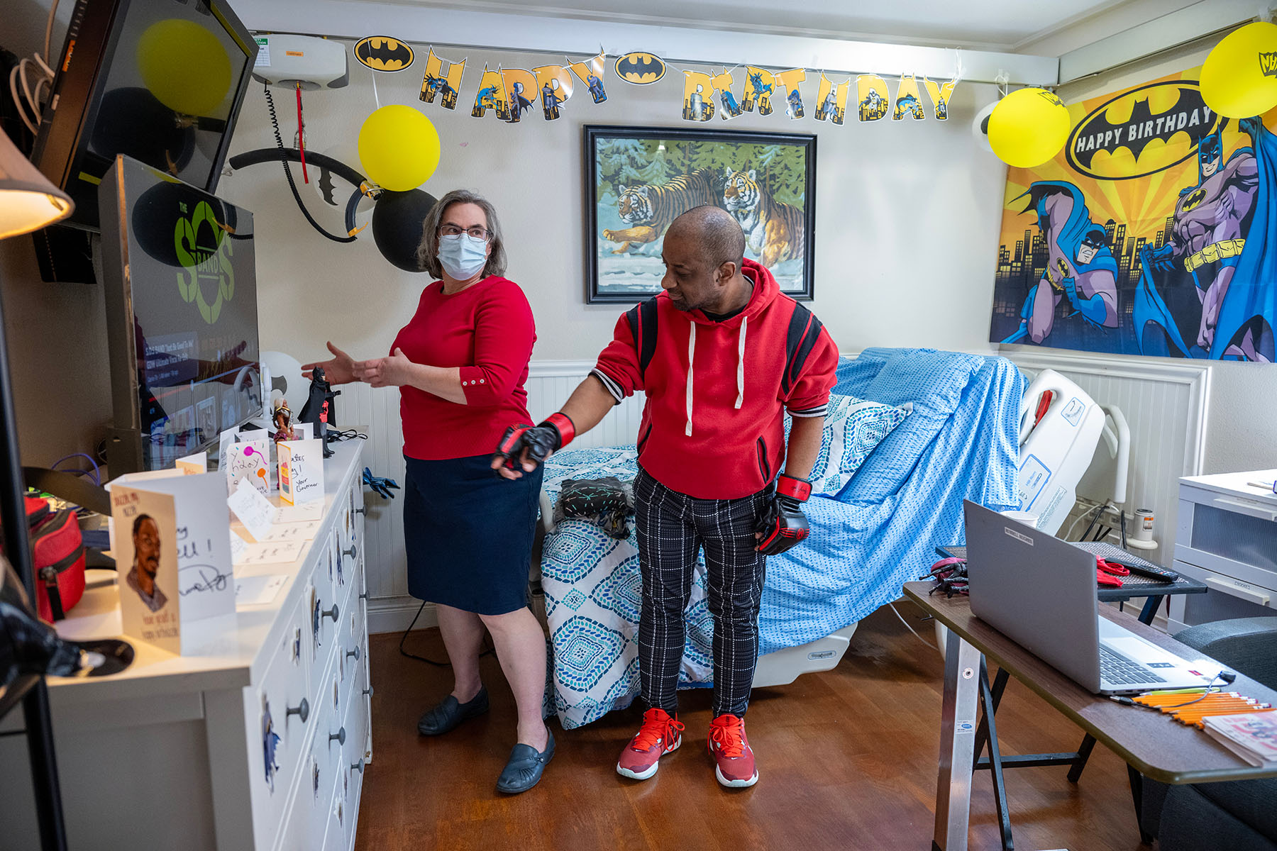 Clarissa Kripke checks in on her patient Russell Hughes in his home bedroom, where there's a hospital bed along with personal Spider Man-themed decorations