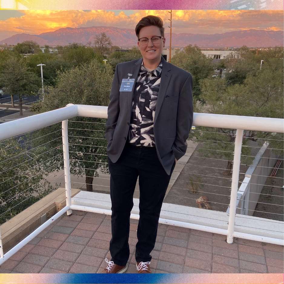 nick smiles at sunset in suit