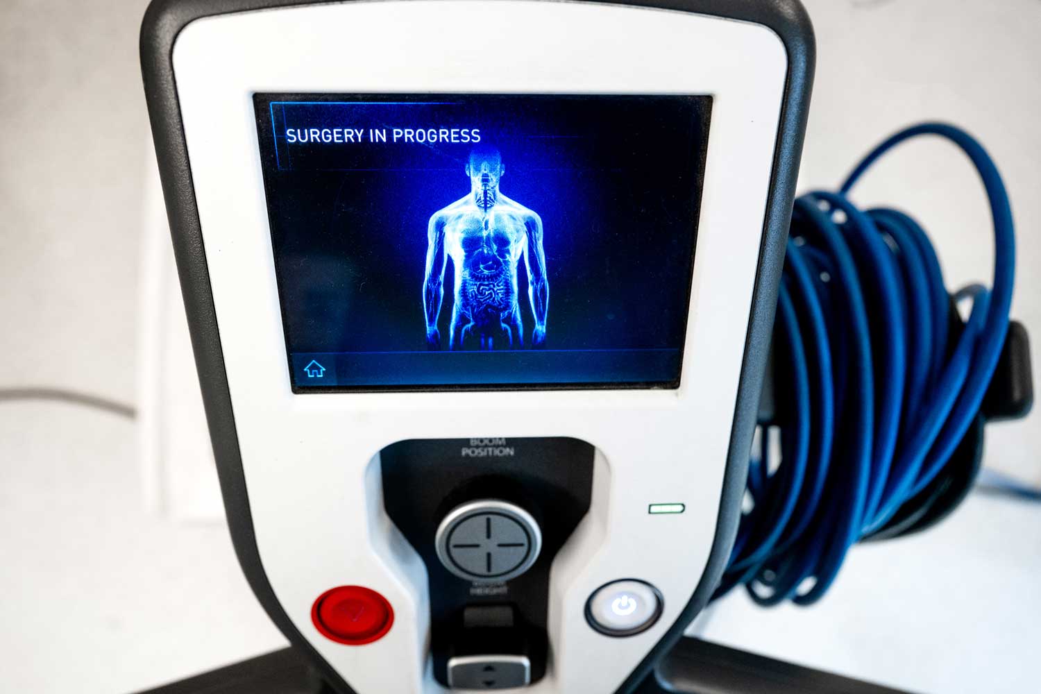 A monitor with a digital screen that reads "Surgery in progress."