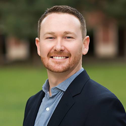 David R. Raleigh portrait in suit.