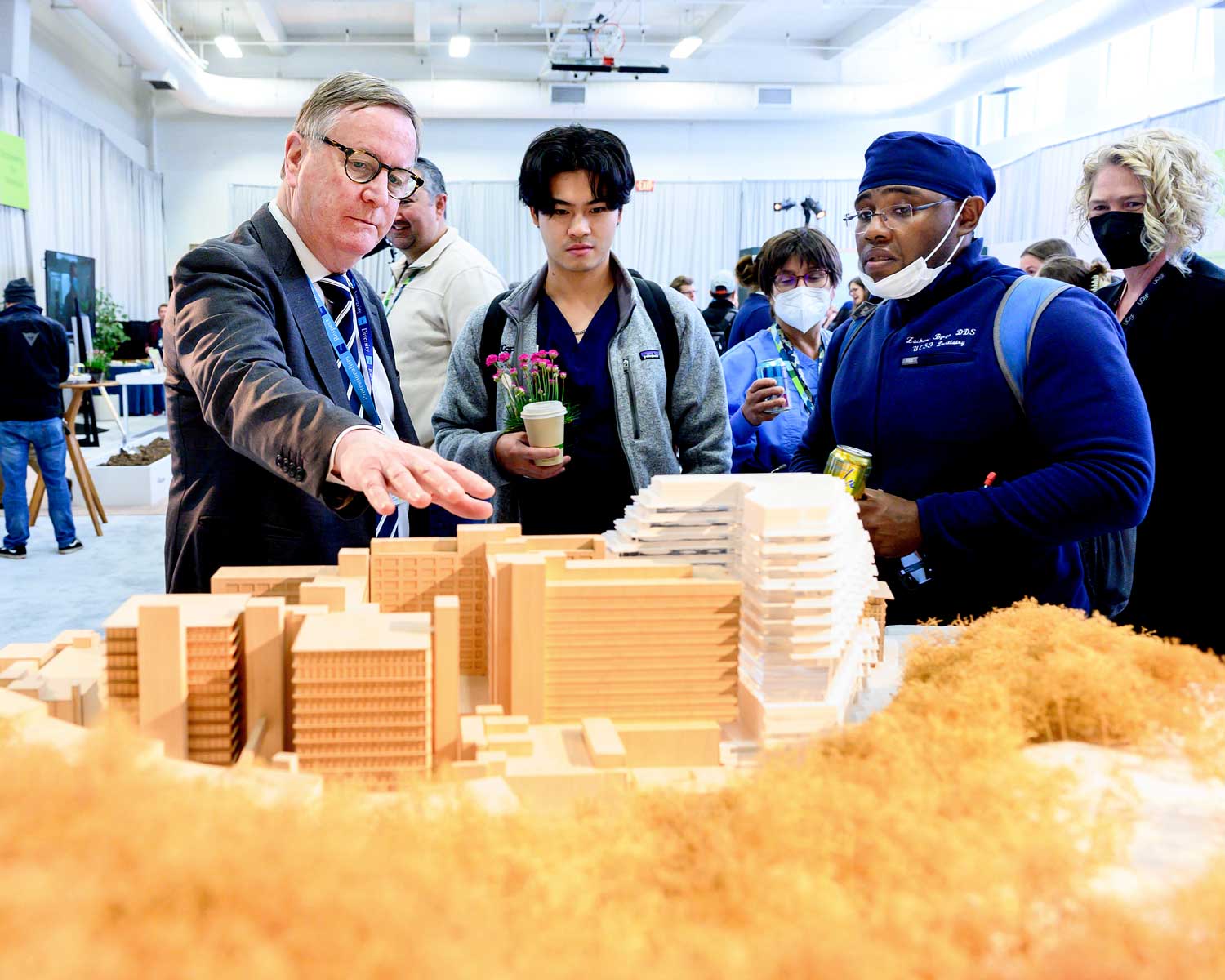 Chancellor Hawgood shows event attendees a 3D model of the renovated Parnassus Heights campus.