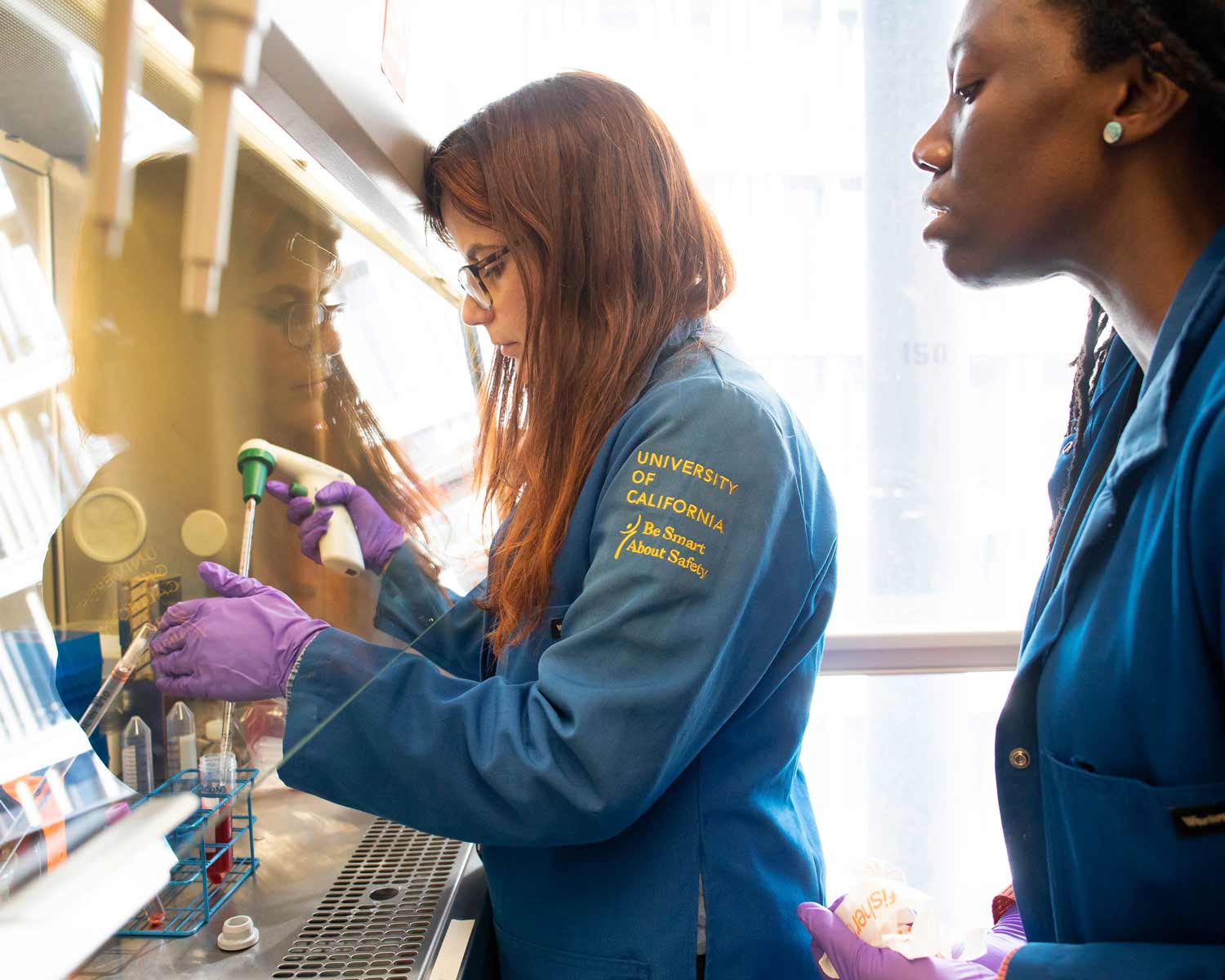 Two lab workers conduct scientific research in a lab.