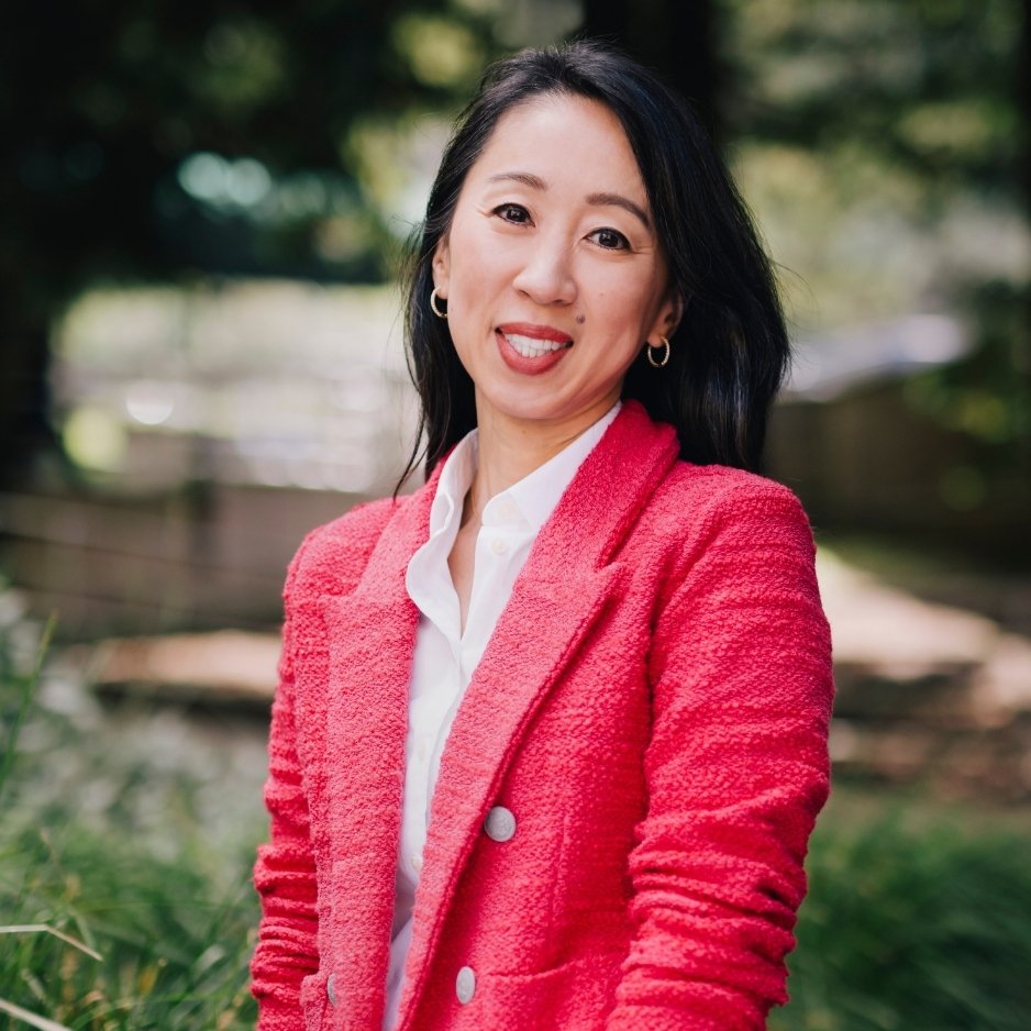 Dr. Linda Park poses in bright red suit coat.