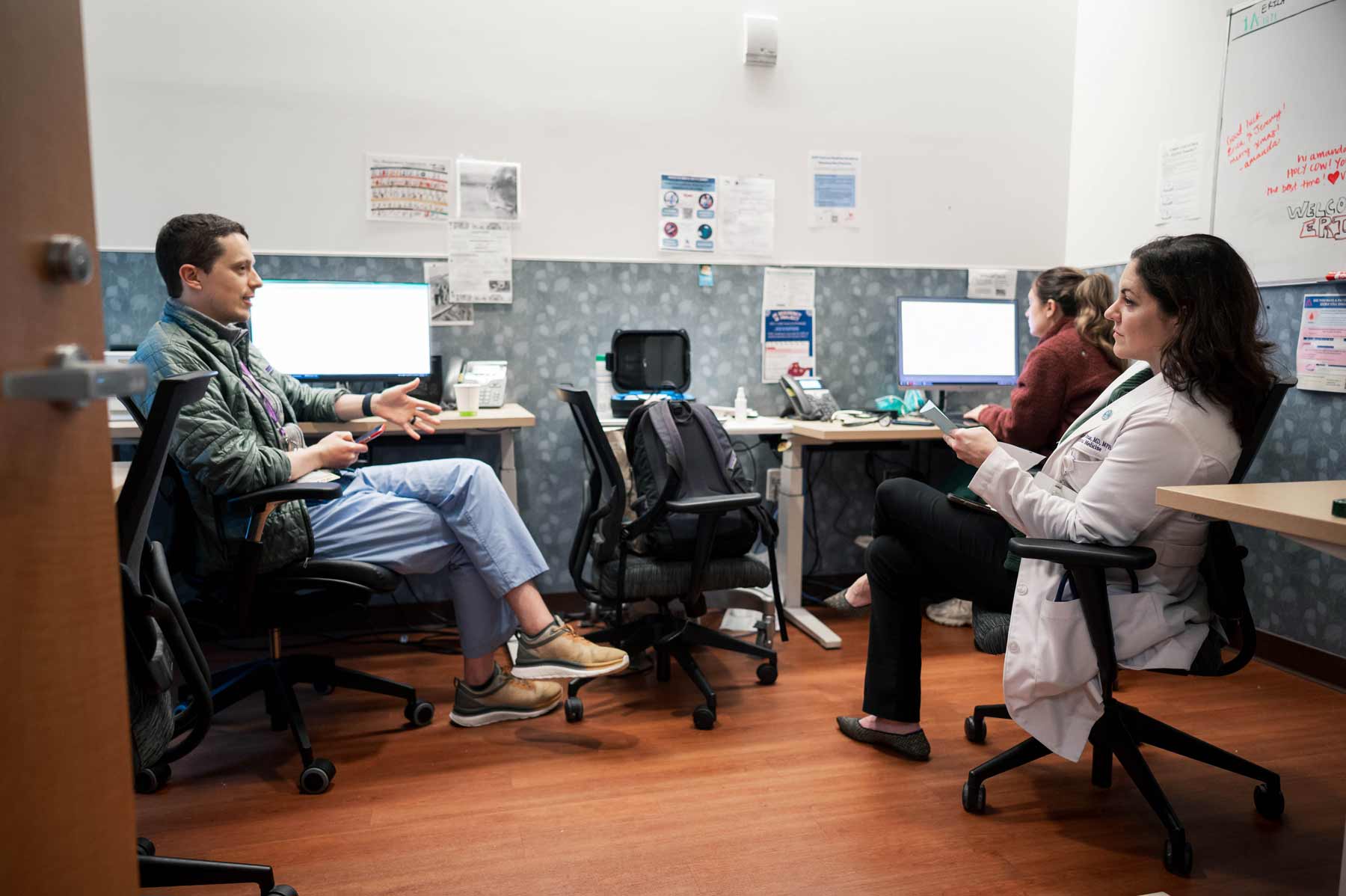 Larissa Thomas sits with two medical residents.